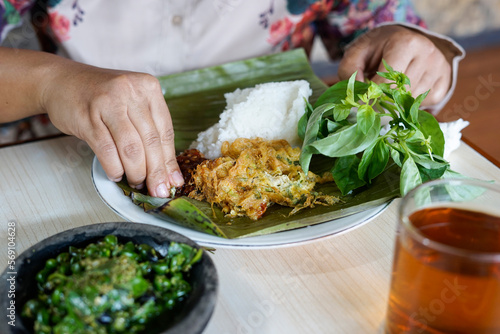 people eat rice complete with vegetables