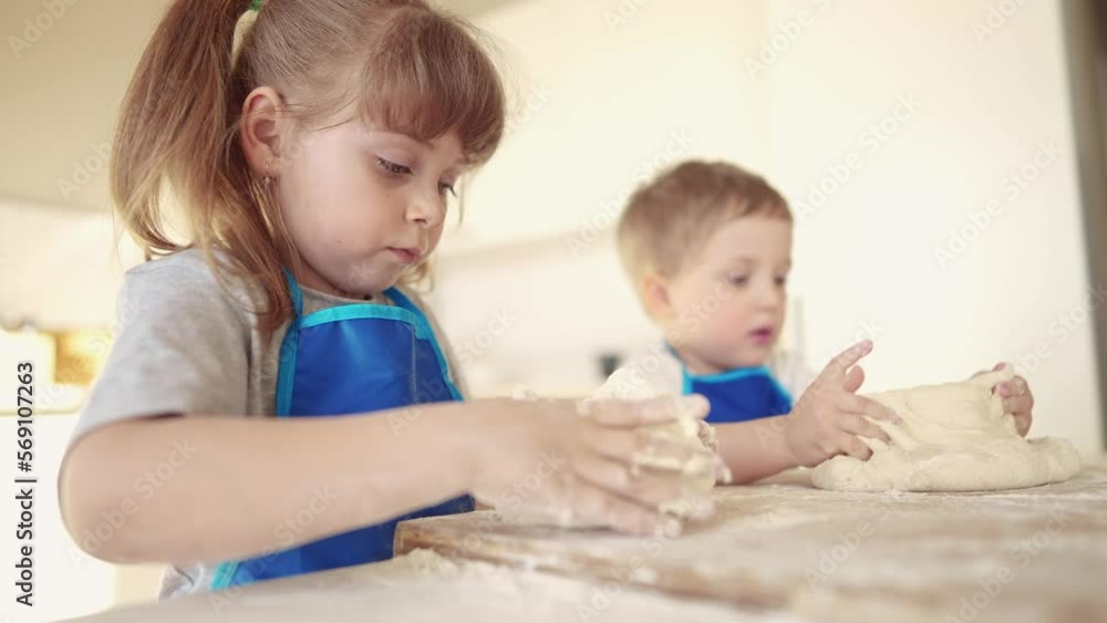 kids are baking. children knead dough and flour in the kitchen. happy family kid concept. baby children bake pizza dough. brother sister baking cookies. teamwork children knead dough and dream flour kids are baking. children knead dough and flour in the kitchen. happy family kid concept. baby children bake pizza dough. brother sister baking cookies. teamwork children knead dough and dream flour