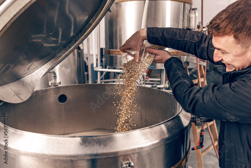 Brewmaster pouring malt seeds photo