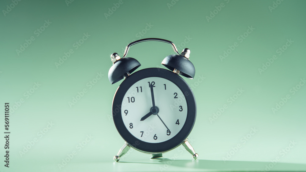 Blue clock showing eight o'clock on green background. Time, timetable, countdown, alarm clock, schedule, deadline. Blue clock showing eight o'clock on green background. Time, timetable, countdown, alarm clock, schedule, deadline.