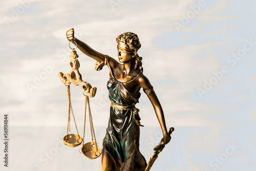 Justice statue on wooden background