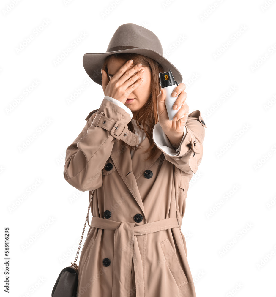Scared young woman with pepper spray for self-defence on white background Scared young woman with pepper spray for self-defence on white background