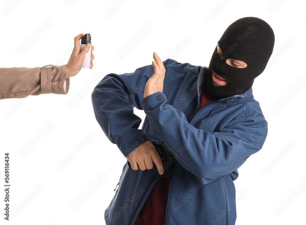 Armed thief and woman with pepper spray for self-defence on white background Armed thief and woman with pepper spray for self-defence on white background