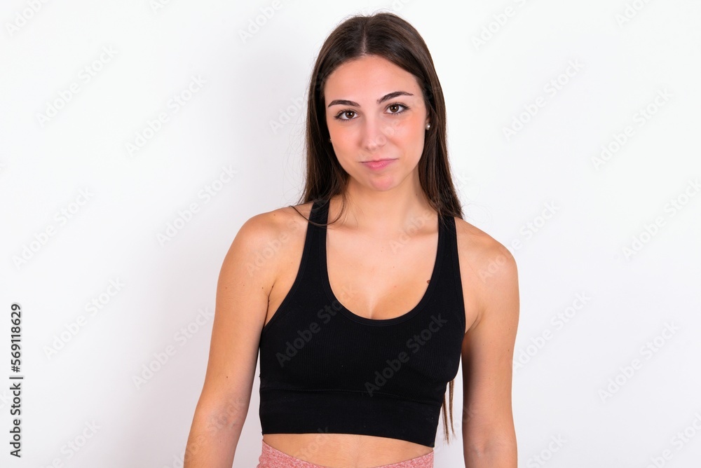 young woman wearing sportswear over white studio background crying desperate and depressed with tears on his eyes suffering pain and depression. Sad facial expression and emotion concept. young woman wearing sportswear over white studio background crying desperate and depressed with tears on his eyes suffering pain and depression. Sad facial expression and emotion concept.