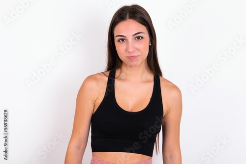 young woman wearing sportswear over white studio background crying desperate and depressed with tears on his eyes suffering pain and depression. Sad facial expression and emotion concept.