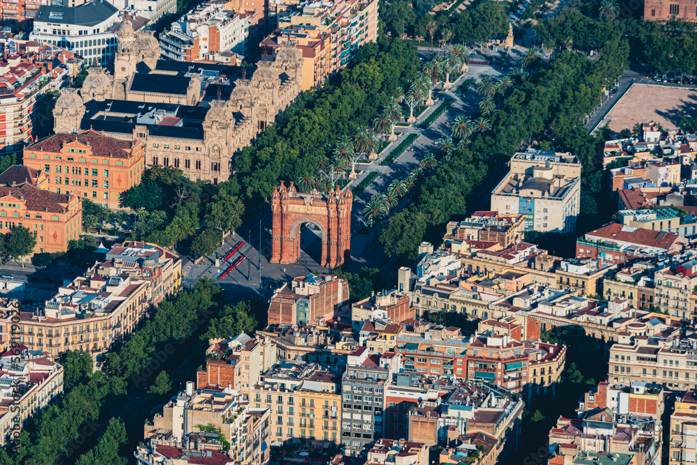 Aerial view of Passeig Lluís Companys with the Arch de Triunfo and with the typical buildings of Barcelona cityscape from helicopter. top view