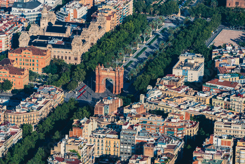 Aerial view of Passeig Lluís Companys with the Arch de Triunfo and with the typical buildings of Barcelona cityscape from helicopter. top view photo
