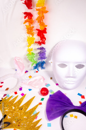 Fototapeta Naklejka Na Ścianę i Meble -  Carnaval costume party items still life with head accessories and color confetti on white background