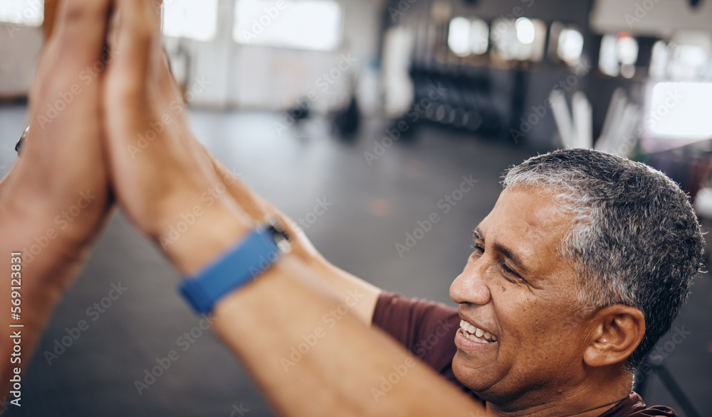 Senior man, high five and exercise in gym, smile and achievement for workout goal and target. Mature male, athlete and gesture for celebration, winning and fitness with support, happiness or wellness Senior man, high five and exercise in gym, smile and achievement for workout goal and target. Mature male, athlete and gesture for celebration, winning and fitness with support, happiness or wellness