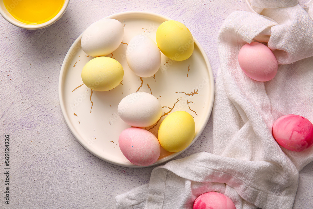 Plate of natural and painted Easter eggs on light background Plate of natural and painted Easter eggs on light background