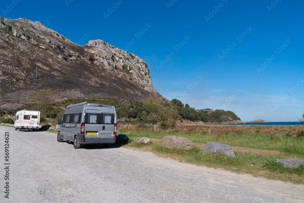 Motorhome and campervan parked by the beach Playa de Orinon Cantabria North Spain located about 50 kilometres from Santander