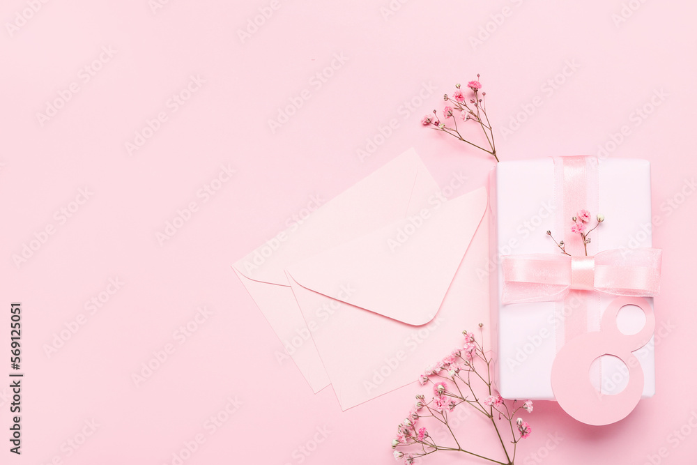 Number 8, envelopes, gypsophila flowers and gift for Women's Day celebration on pink background