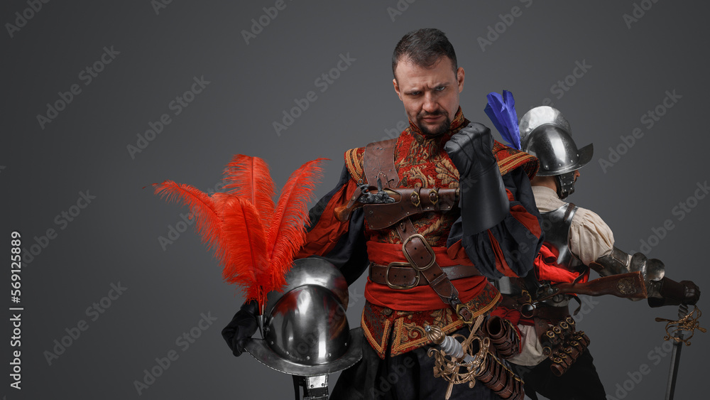 Naklejka premium Portrait of team of conquistadors dressed in costumes with swords.