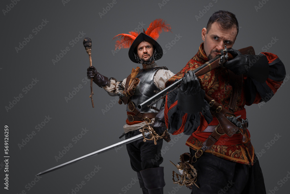 Portrait of isolated on gray background two conquistadors with rifle and torch. Portrait of isolated on gray background two conquistadors with rifle and torch.