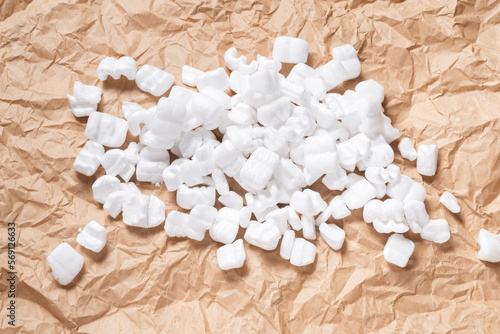 White Packaging Chips, Styrofoam peanut on carton background photo