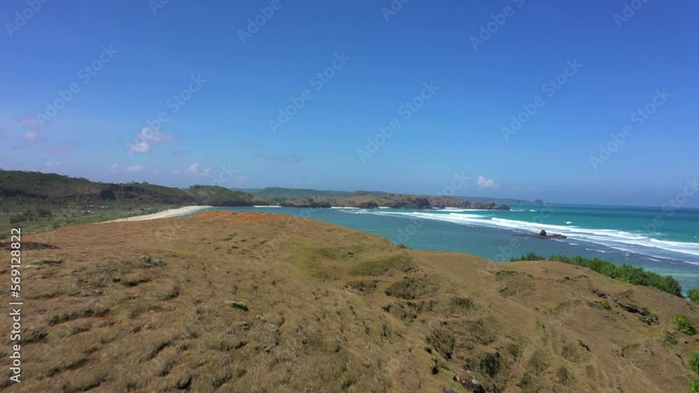 Aerial: Drone Shot Of Beautiful Beach With Mountains Against Sky On Sunny Day - Lombok, Indonesia Aerial: Drone Shot Of Beautiful Beach With Mountains Against Sky On Sunny Day - Lombok, Indonesia