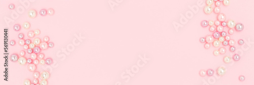 Banner with imitation pearl beads on a pink pastel background. Needlecraft creative concept with copy space.