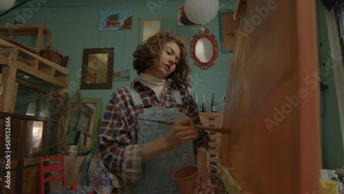 Wallpaper Mural Woman Drawing On Canvas. Artist painting using brush standing in workshop. Painter working in creative workspace. Torontodigital.ca