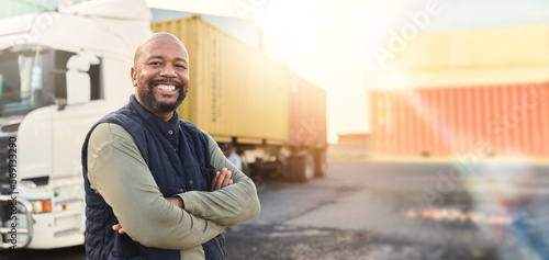 Man, portrait and arms crossed by truck, container stack and happy for transport job. Driver, smile and shipping cargo freight with happiness in transportation service, stock delivery or supply chain