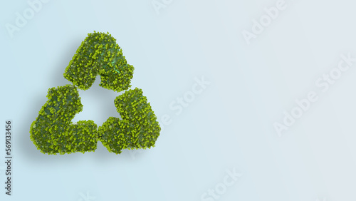 Recycle sign covered in trees