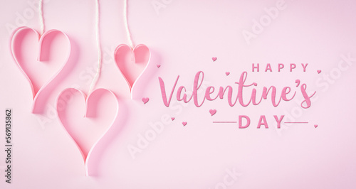 Pink paper hearts and the text on pastel paper background. Love and Valentine's day concept. © Siam