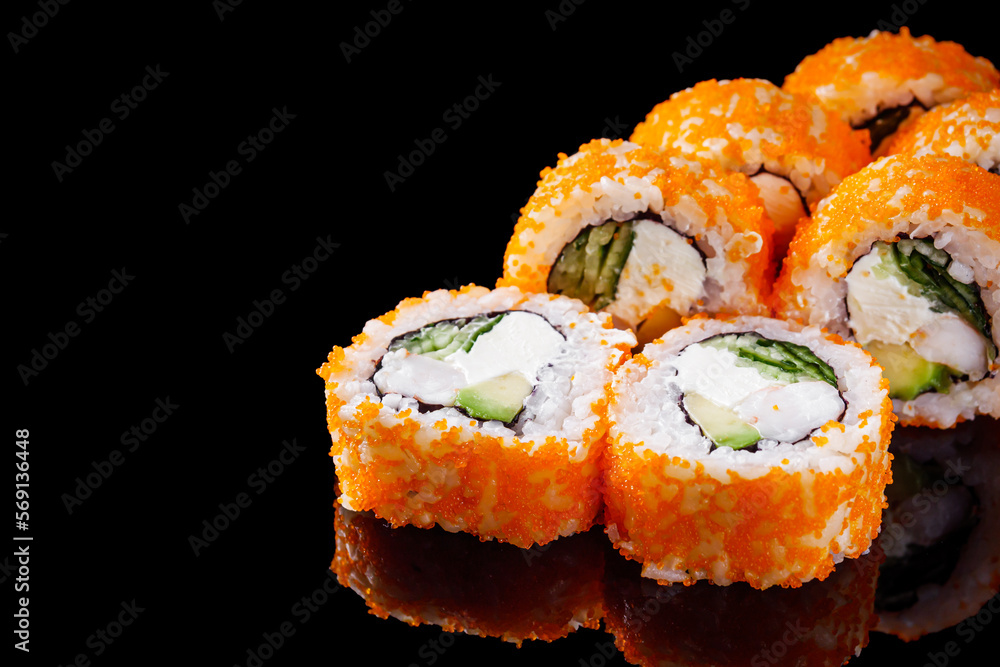 sushi roll with shrimp tobiko cucumber cream cheese avocado on a black mirror background sushi roll with shrimp tobiko cucumber cream cheese avocado on a black mirror background