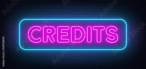 Credits neon sign on brick wall background.