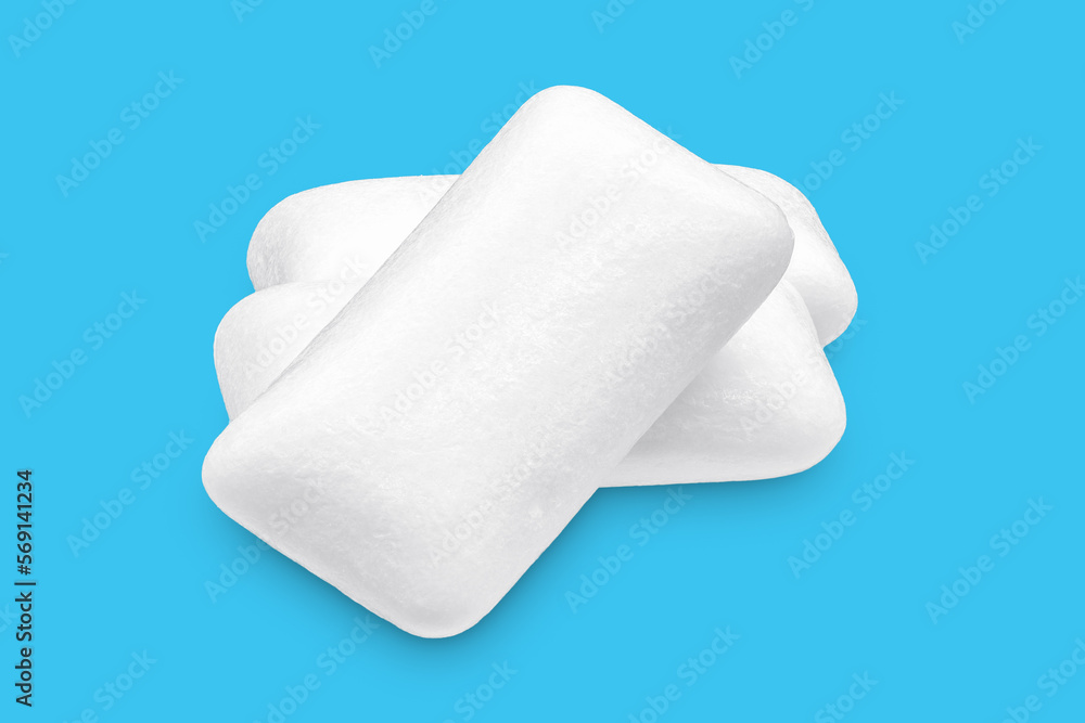 Three pieces of white chewing gum isolated on white. The whole subject is in focus. Three pieces of white chewing gum isolated on white. The whole subject is in focus.