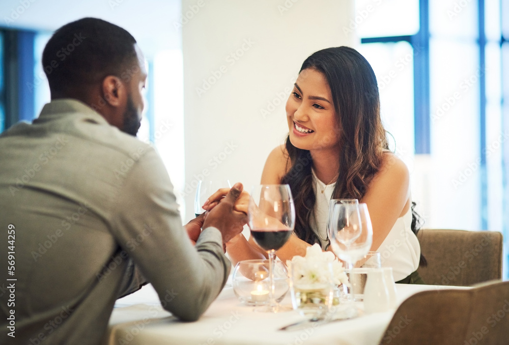 Wine, date and interracial couple holding hands for fine dining, restaurant or valentines celebration together. Black man, asian woman and alcohol glasses for romance, wealth or luxury anniversary Wine, date and interracial couple holding hands for fine dining, restaurant or valentines celebration together. Black man, asian woman and alcohol glasses for romance, wealth or luxury anniversary