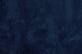Navy blue color textured surface. Dark textile texture. Indigo colour abstract grunge background