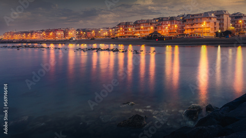 houses lit up at the blue hour on the waterfront