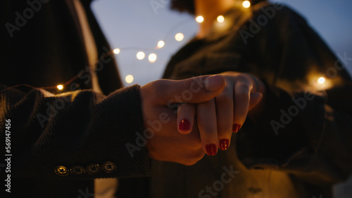 Hand of couple in silhouette touching together during valentine's day