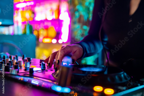 DJ Hands creating and regulating music on dj console mixer in concert nightclub stage