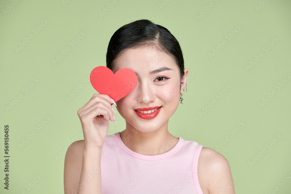pretty Asian woman with toothy smile while holding Valentines Day card in hands, pretty Asian woman with toothy smile while holding Valentines Day card in hands,