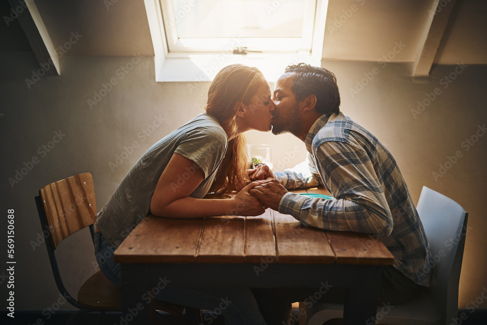 Kiss, couple love and holding hands at cafe on table, passion or bonding together. Valentines day, romance diversity and affection of man and woman on date, kissing and enjoying time in restaurant. Kiss, couple love and holding hands at cafe on table, passion or bonding together. Valentines day, romance diversity and affection of man and woman on date, kissing and enjoying time in restaurant.