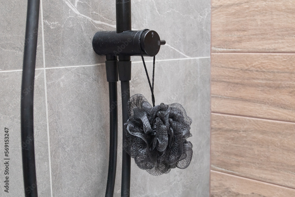 Black washcloth in the shower in modern bathroom