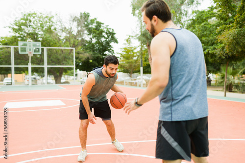 Friends working out playing sports on the basketball court