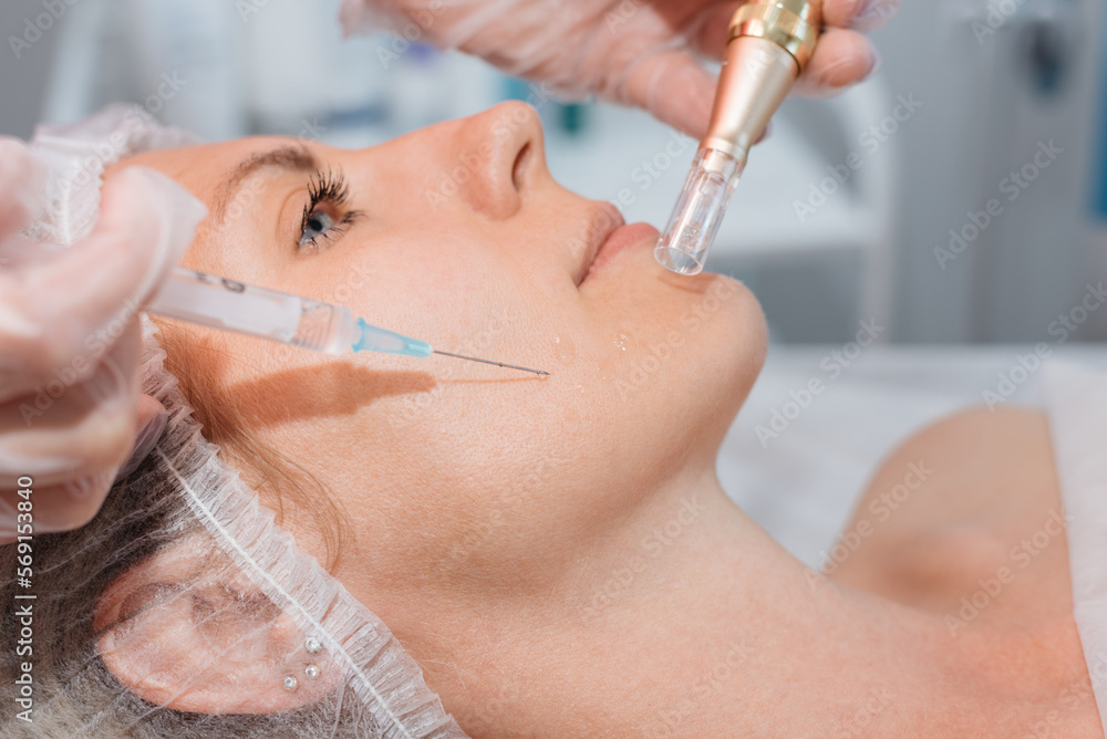 Cute woman gets facial injections procedure in beauty salon. Cosmetology and professional skin care Cute woman gets facial injections procedure in beauty salon. Cosmetology and professional skin care