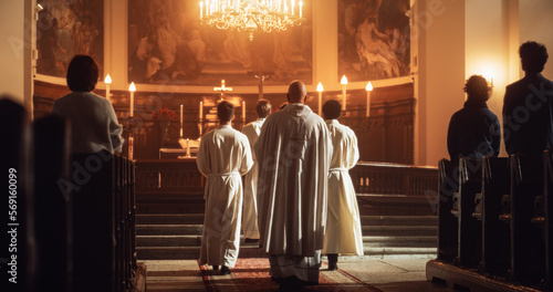 Back View: Procession Of Ministers of Christianity, Bearing Holy Cross to Altar, As Congregation Looks In Wonder. Christians Rejoice In Celebration Of Divine Mass. Sacred Place Filled With Joy. photo