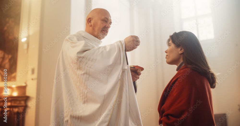 In Church Ceremony of Holy Communion, Eucharist or Last Supper: Christian Minister Breaking bread, Giving it to Parishioner, act of Unity with Jesus Christ, Saviour Who Sacrificed Himself for People
