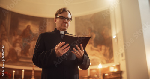 Vászonkép In Christian Church: The Minister Leads The Congregation In Prayer and Reads From The Holy Book, The Bible, Gospel of Jesus