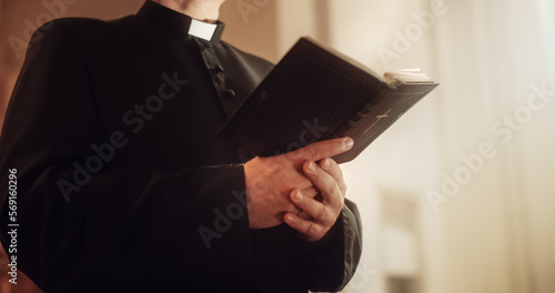 In Christian Church: Close Up of The Bible, Gospel of Jesus. Minister Leads The Congregation In Prayer and Reads From The Holy Book, Priest Providing Guidance, Belief, Hope to People. photo