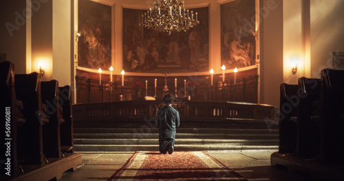 Fototapet Back View: Christian Man Getting on his Knees and Starting to Pray in a Church