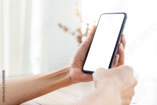 cell phone blank white screen mockup.hand holding texting using mobile on desk at office.background empty space for advertise.work people contact marketing business,technology