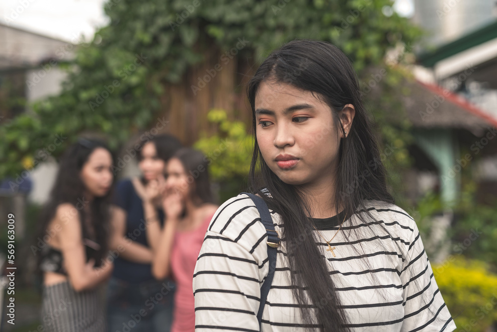 A woman notices three ladies apparently talking negatively or spreading malicious gossip behind her back. Issues among women. A woman notices three ladies apparently talking negatively or spreading malicious gossip behind her back. Issues among women.