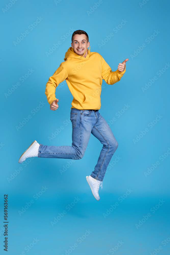 young happy man in casual clothes jumping young happy man in casual clothes jumping