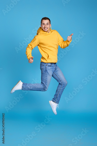 young happy man in casual clothes jumping
