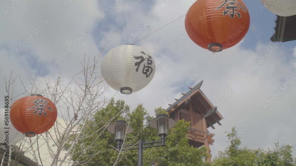 The red Chinese lanterns hanging in front of the gate of Chinese temple