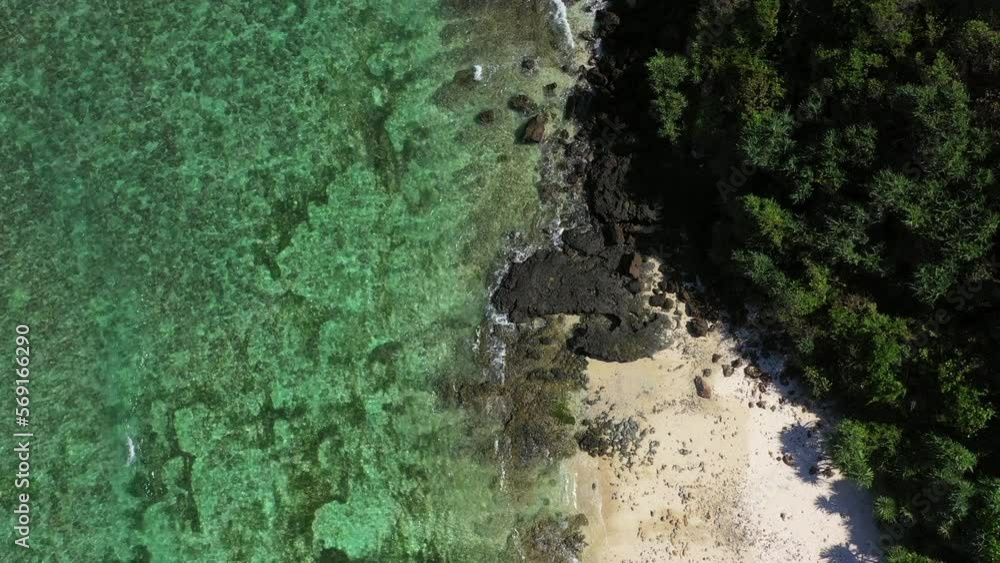 Aerial Top Shot Of Turquoise Sea Coastline At Beach, Drone Flying Backwards On Sunny Day - Lombok, Indonesia Aerial Top Shot Of Turquoise Sea Coastline At Beach, Drone Flying Backwards On Sunny Day - Lombok, Indonesia
