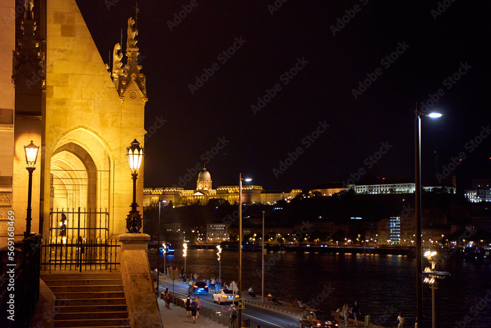 Obraz premium Evening photo of the Parliament building in Budapest.The majestic Saxon architecture is illuminated with warm yellow light